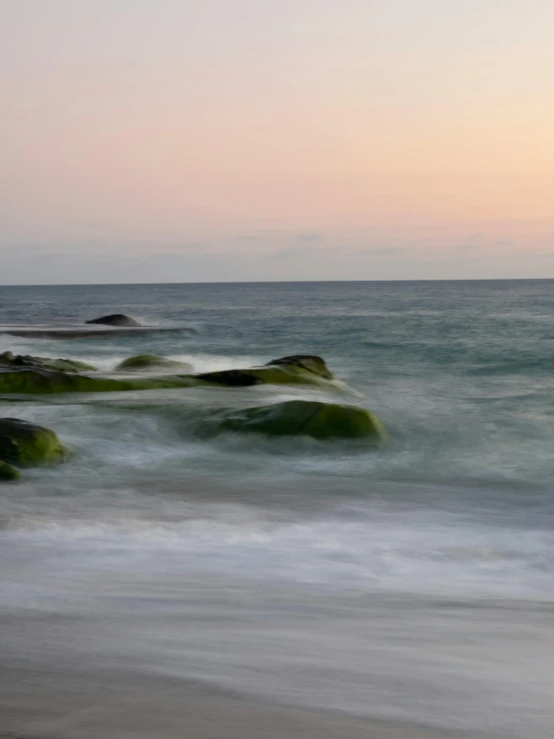 a couple of large rocks sitting in the middle of the ocean