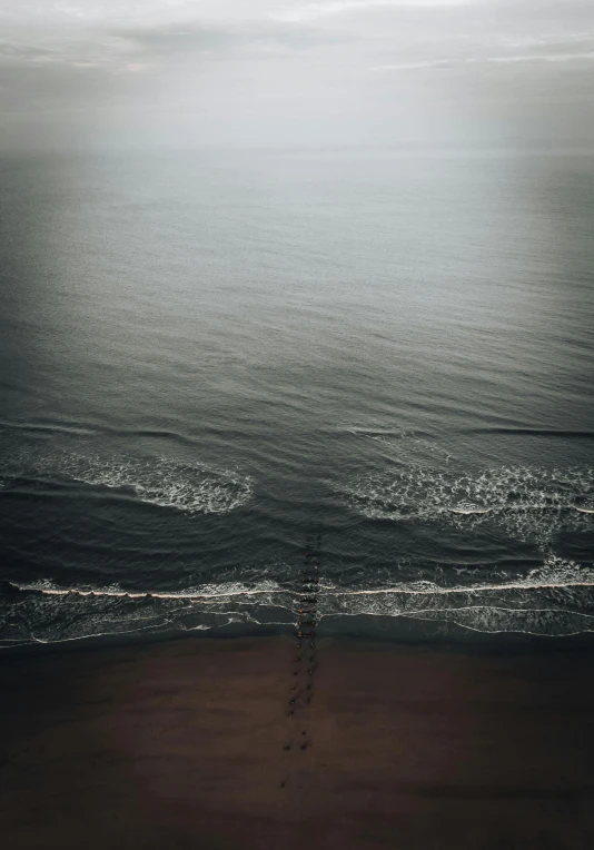 an aerial view of the beach with ocean water