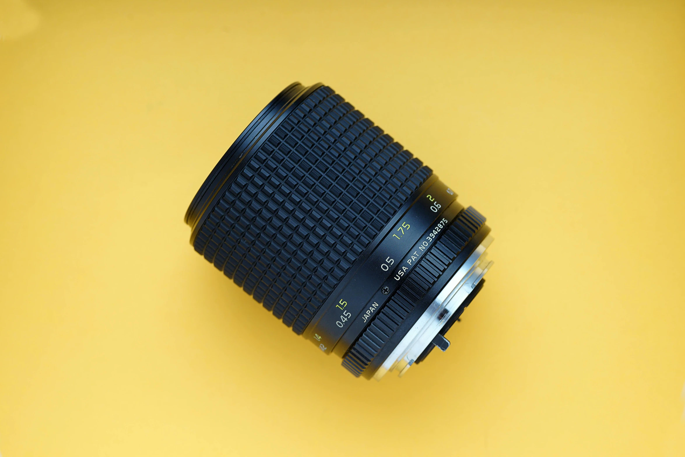 a camera lens on a yellow background