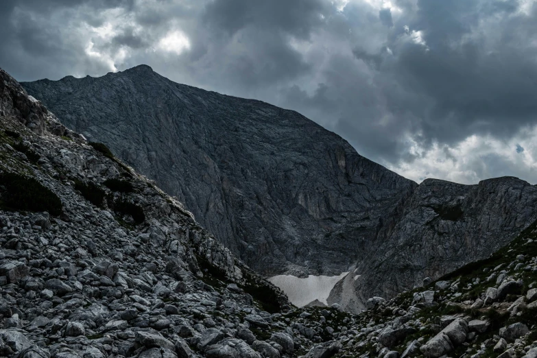 dark, stormy sky hangs over a high mountain