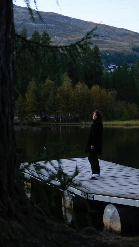 a person is standing on the end of a dock