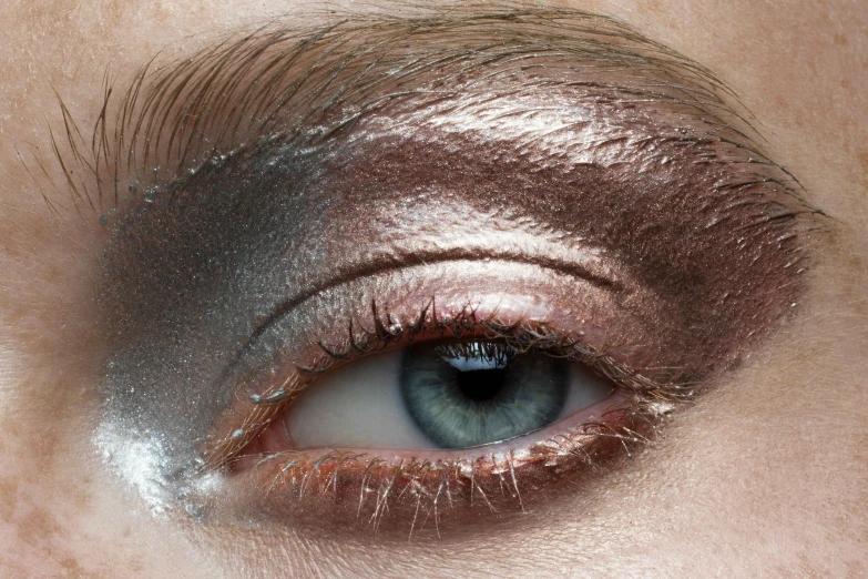 a woman's silver eye with metal foil on it