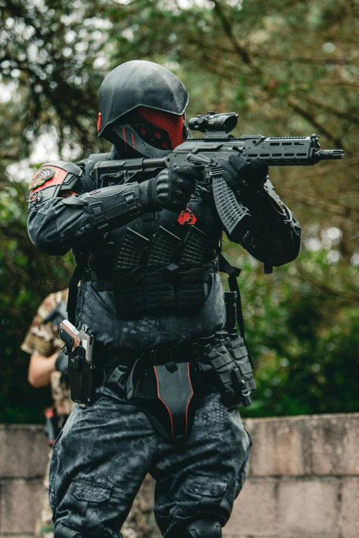 a man wearing full gear holding a rifle