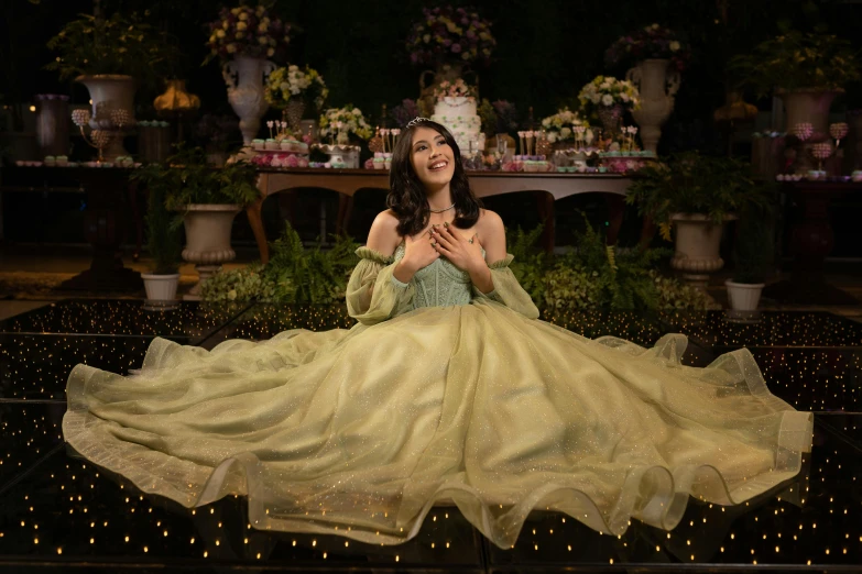 a girl wearing a dress sitting on a black table