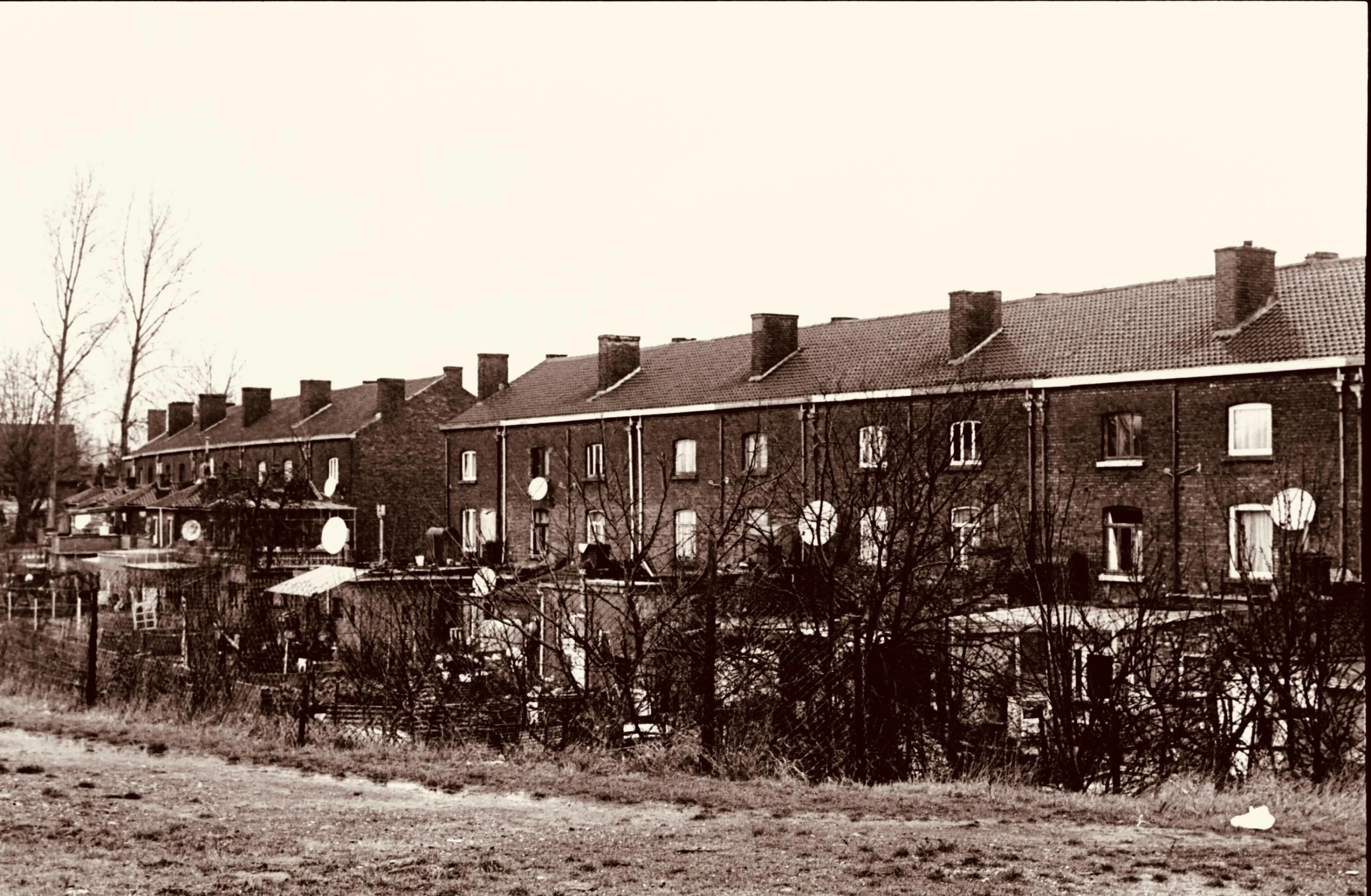 black and white pograph of several brick houses