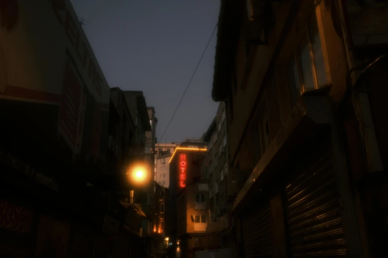 a view down a dark alleyway during twilight