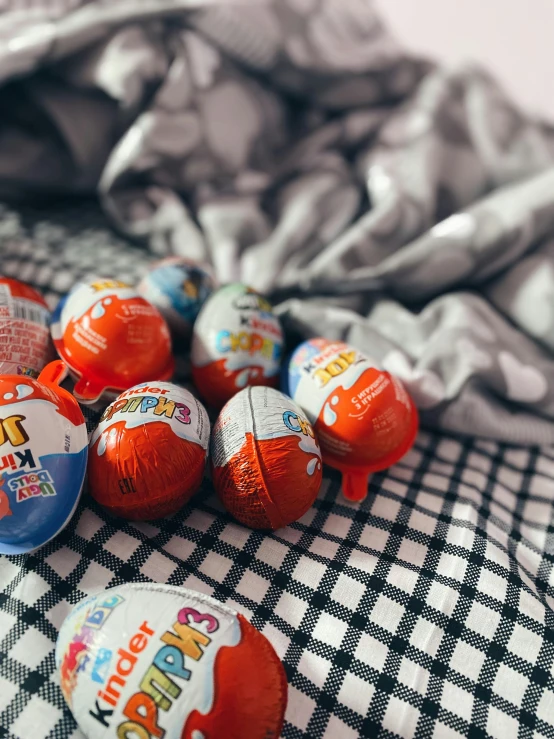 a bunch of different colored candies with a checkered table cloth