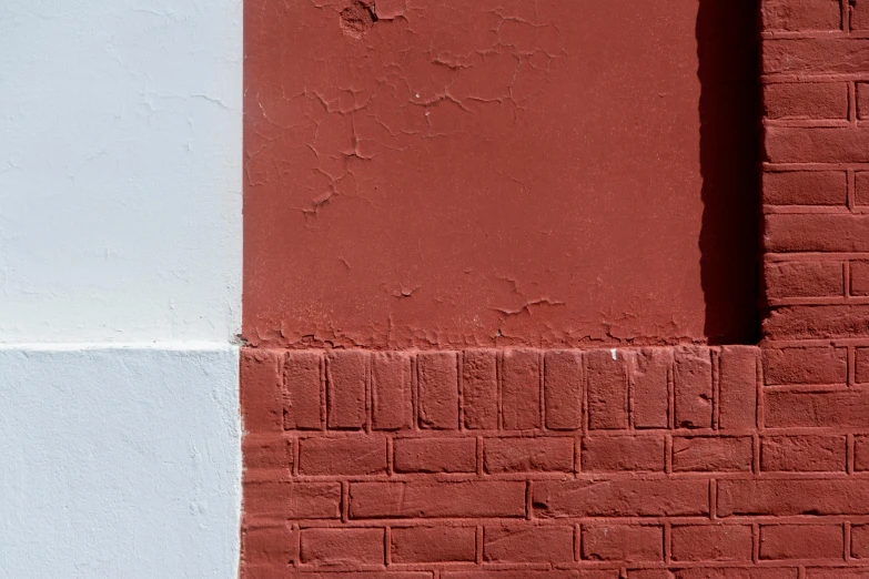 the side of a building with different colored bricks