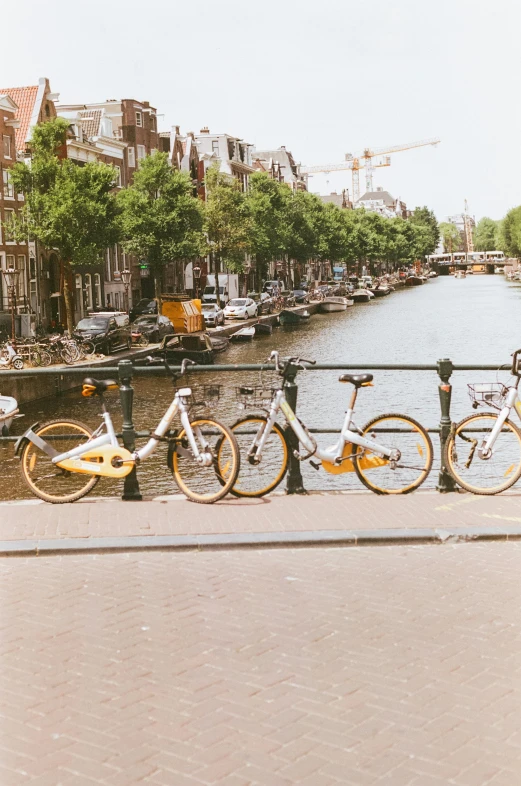 three yellow bicycles parked next to each other