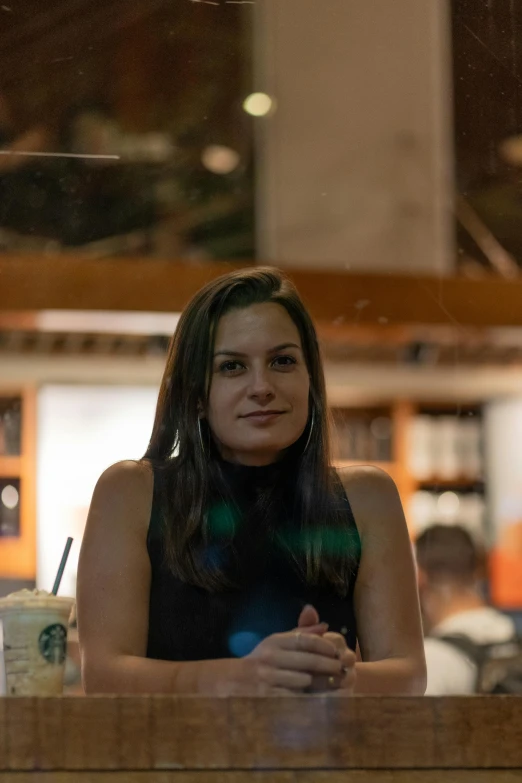 woman sitting in front of a counter top with her arms crossed