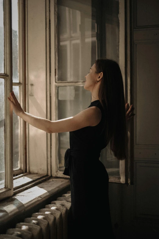 a woman holding a window pane with her hand