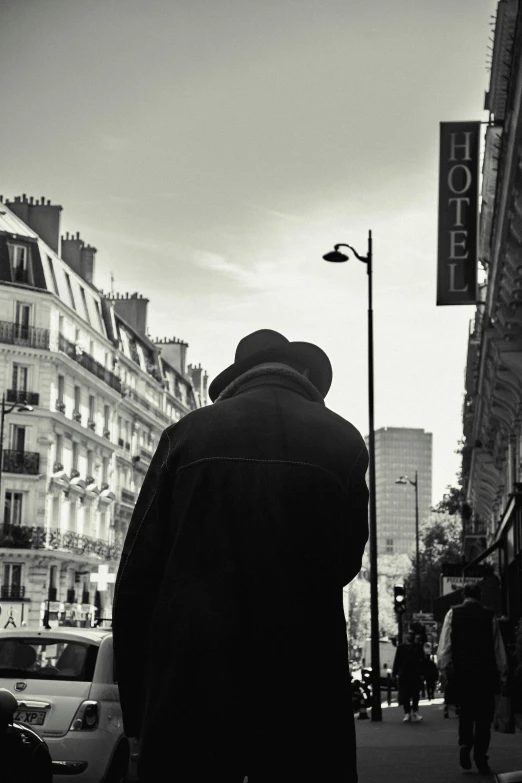 the man stands in front of a street sign