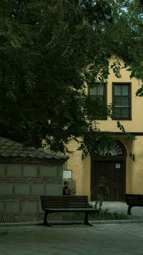 two empty benches in front of an old house