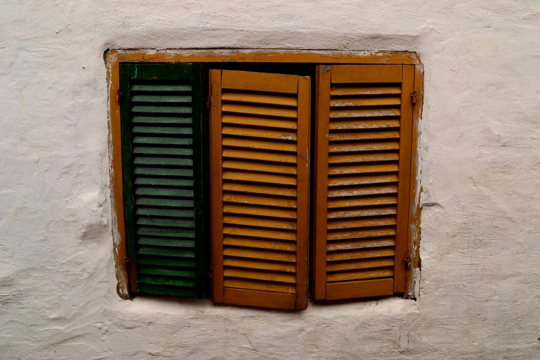 closed wooden shutters on an open window
