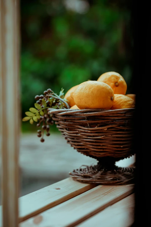 some oranges and other fruits are in a wicker basket