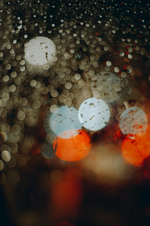 rain drops on a window, with several colorful lights