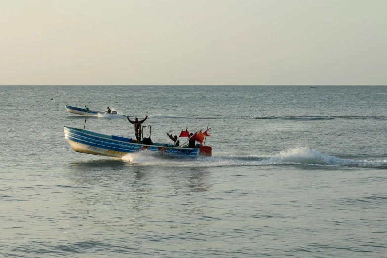 two men are on a boat in the ocean