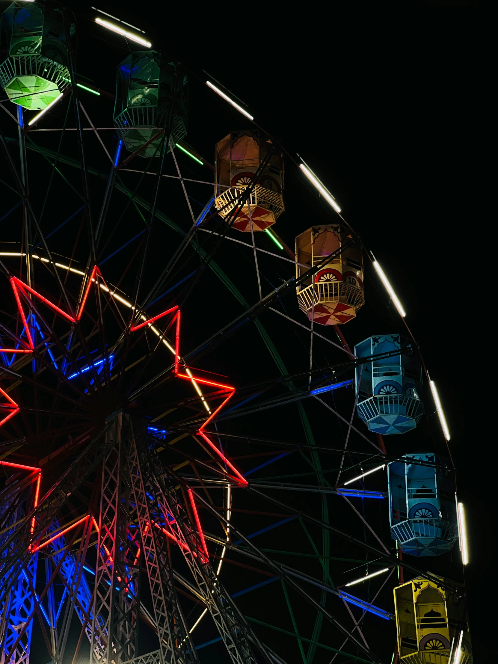 a ferris wheel is lit up at night