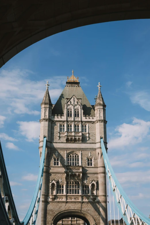 tower bridge from the bottom with some blue arches