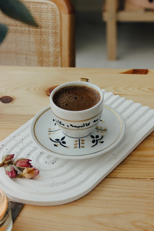 a coffee cup and saucer on a tray