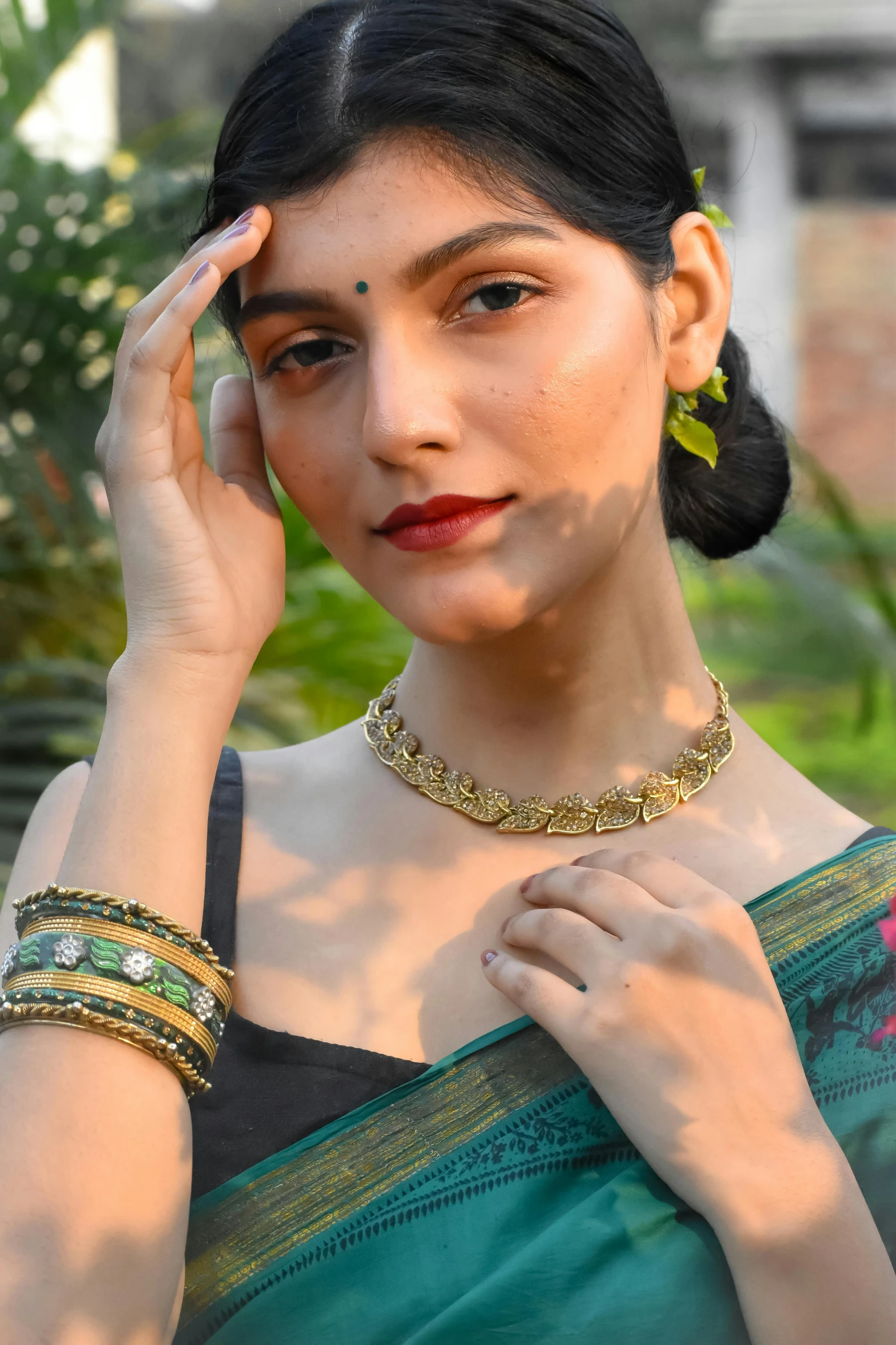 a woman posing with her hand on her face