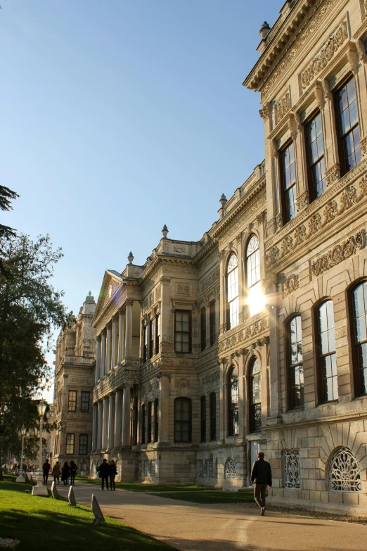 people are walking past a group of large buildings