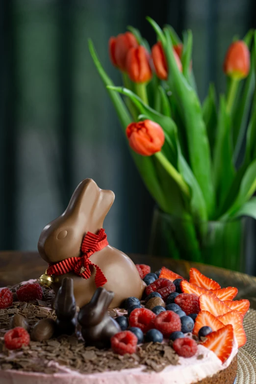 a chocolate bunny with berry and chocolate shavings on it