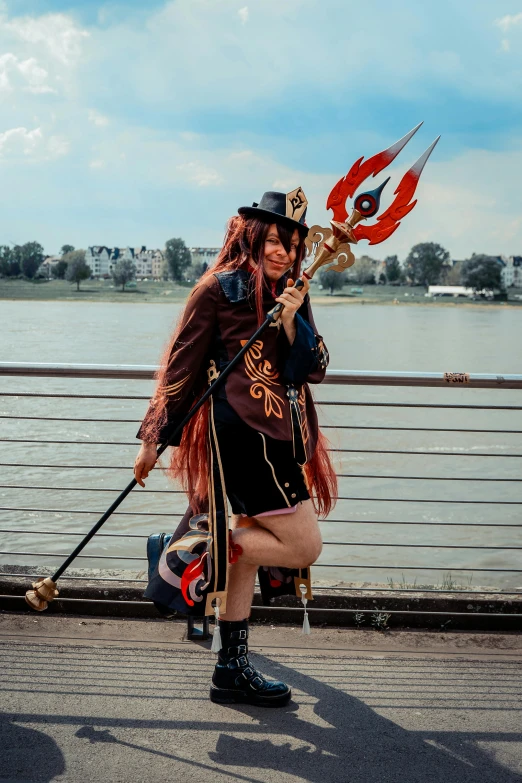 a woman wearing a pirate costume holding a large hook on her shoulder