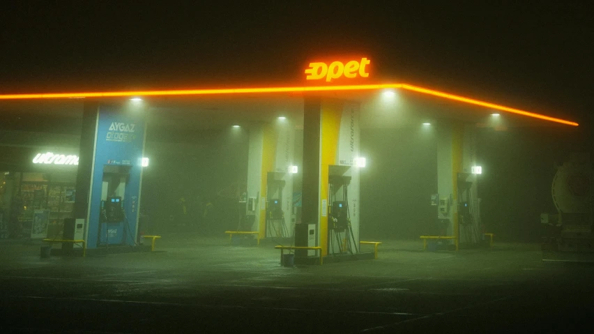 an empty gas station with a bright light on top
