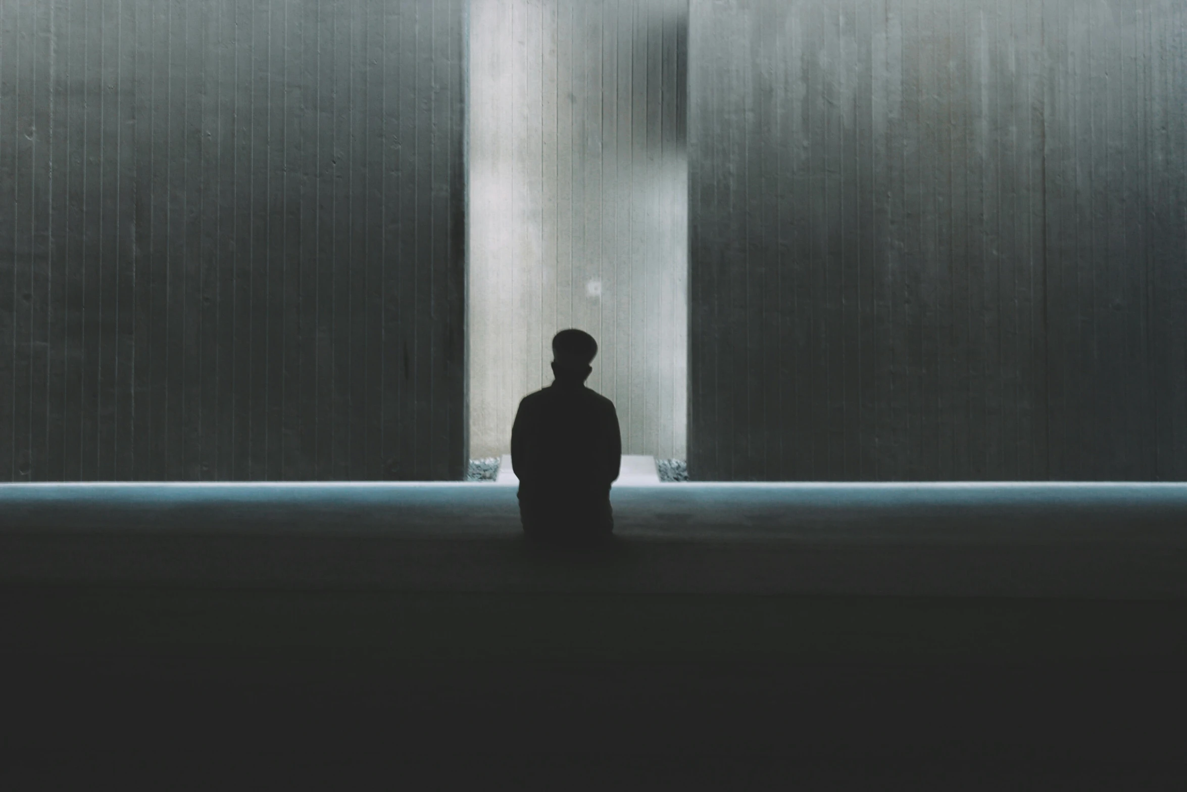 a man standing in an empty room at night