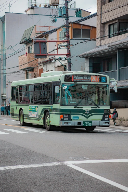 the city bus is traveling down the street