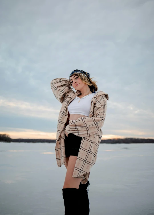 a woman that is standing by some water