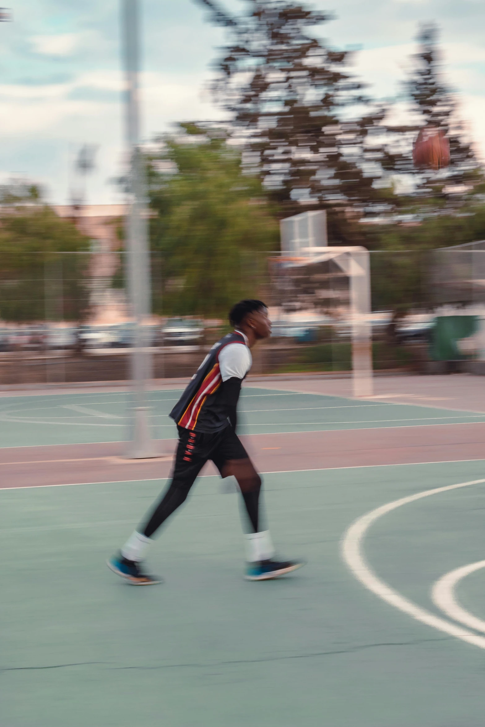 a man is running on the court with a basketball in his hand