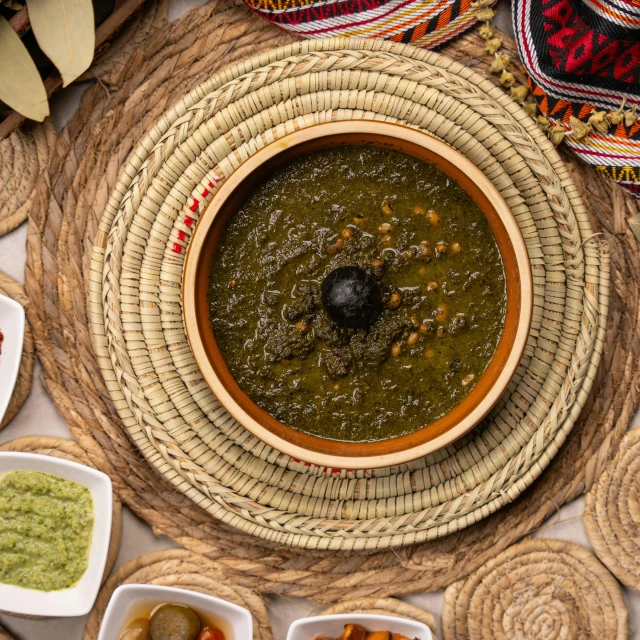 several small dishes sit on the ground next to a bowl of food