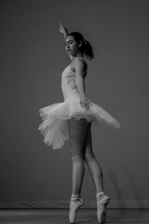 a young woman wearing white ballet shoes