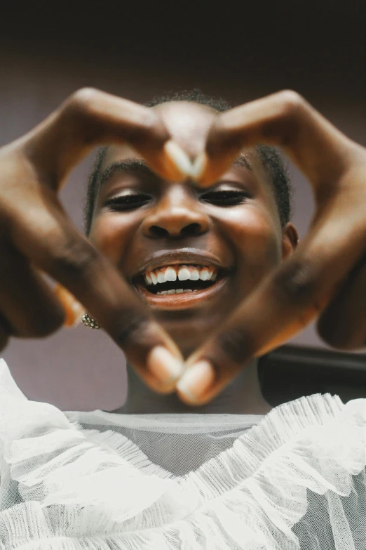 a person making a heart with their hands