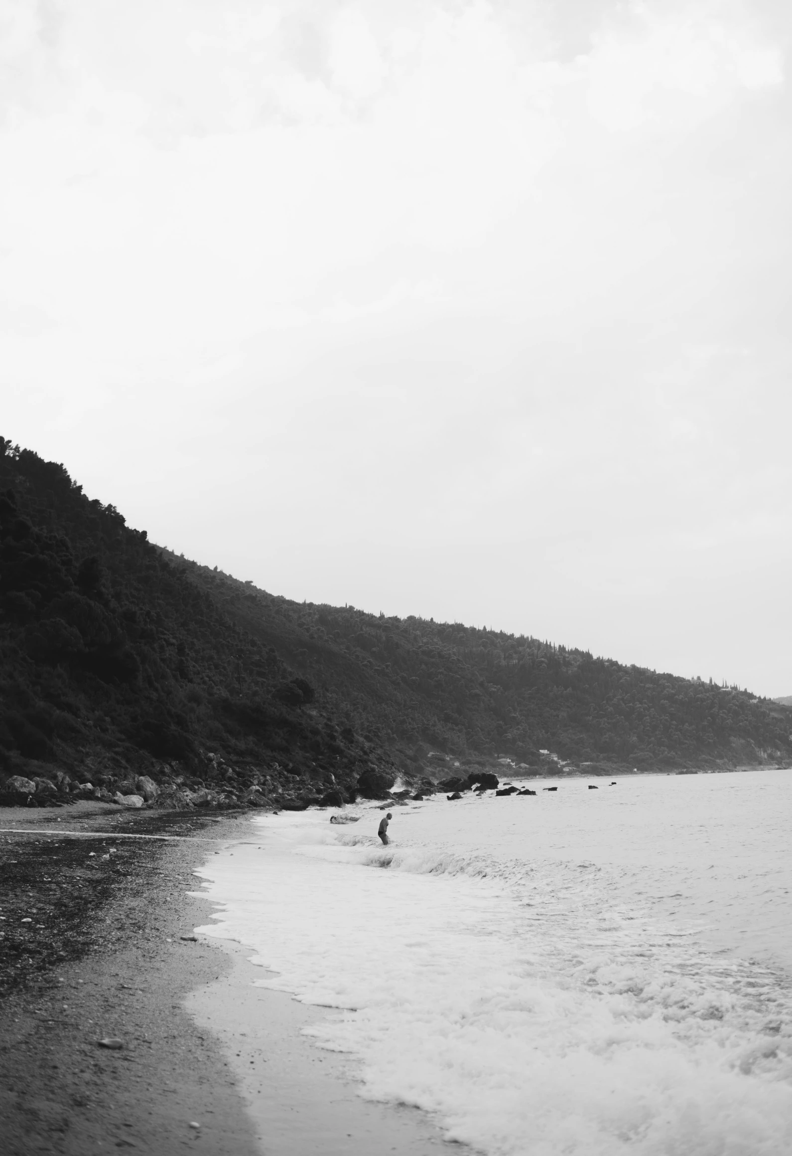 a black and white po of two people on a beach