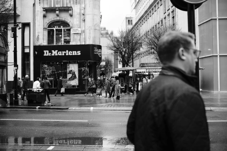 an old picture of a city street with people