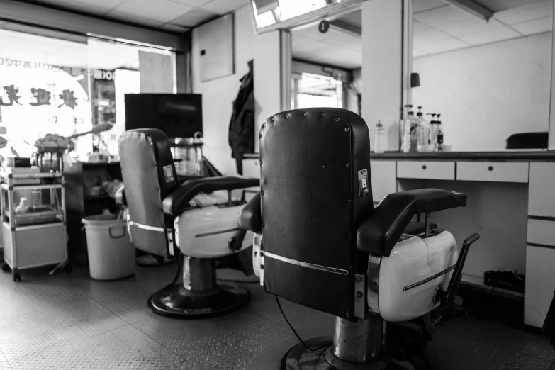 a chair and other chairs are arranged in a hairdressing area