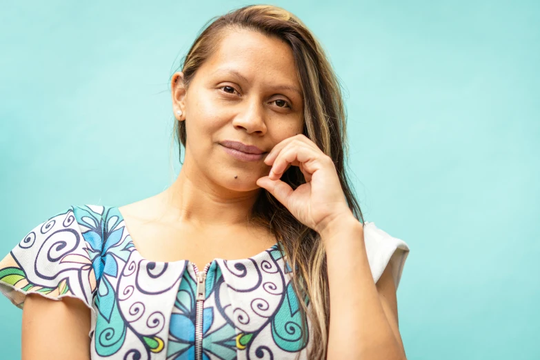 a woman with ids and a floral shirt posing for a po