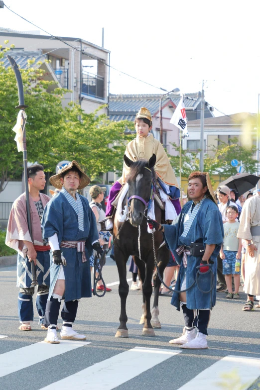 two people and a  in blue standing next to a black horse