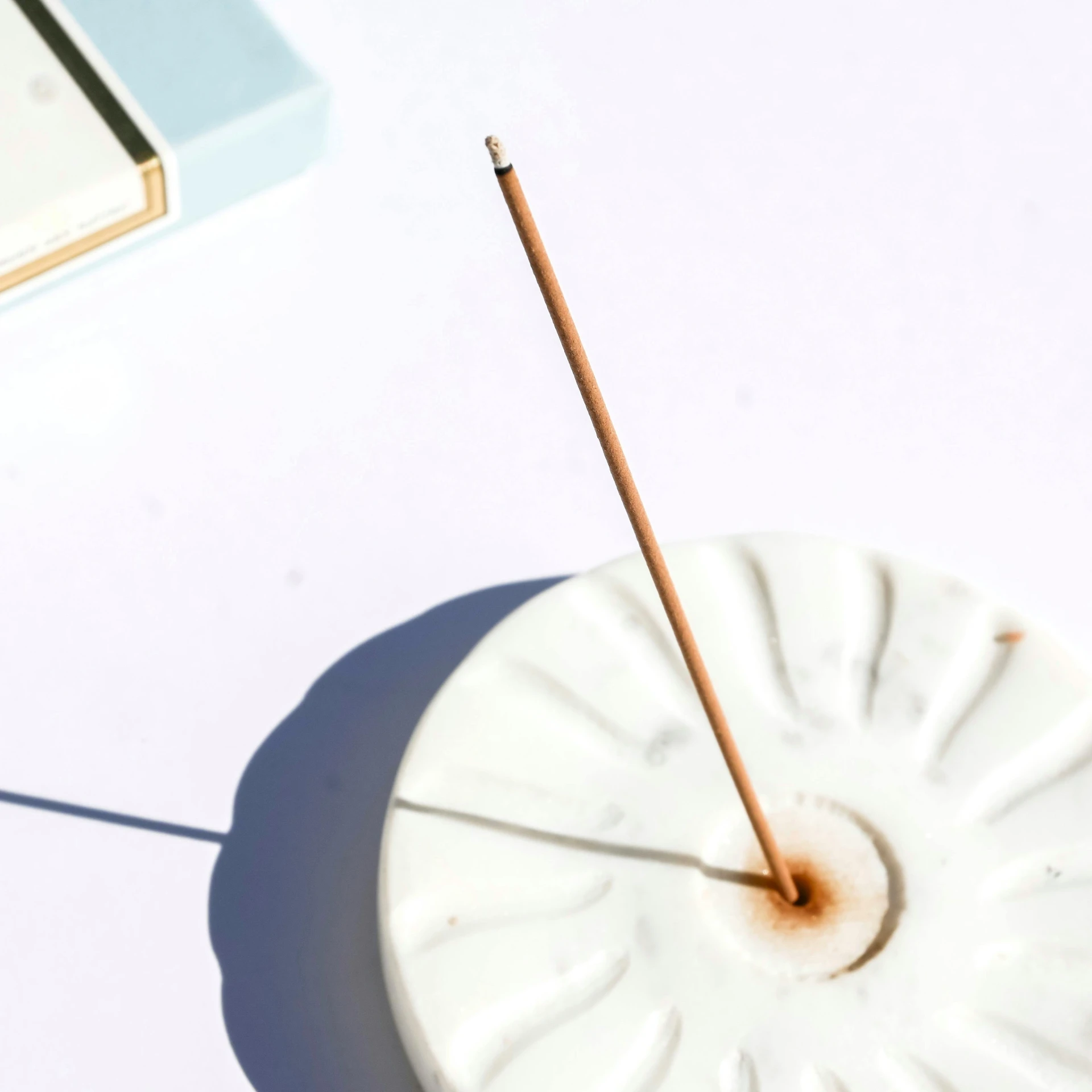 a single stick is placed in a decorative bowl