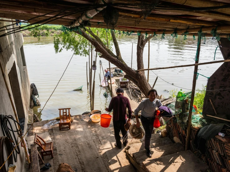 some people in front of some water with many cages