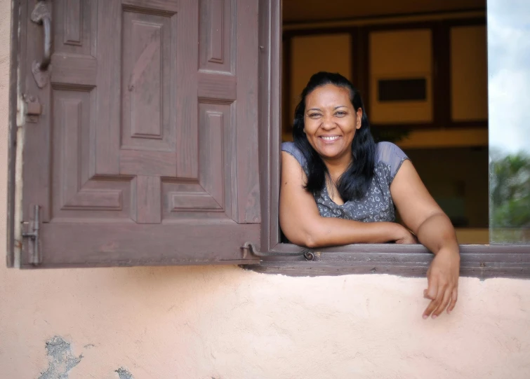 an indian woman leaning out of a window