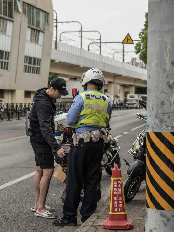 two police officers standing next to a street on a corner