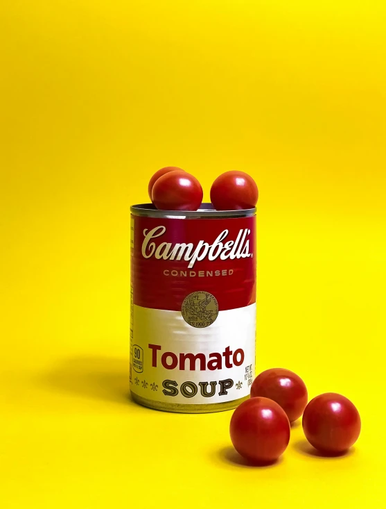 tomatoes are spilling out from a campbell's tomato soup can