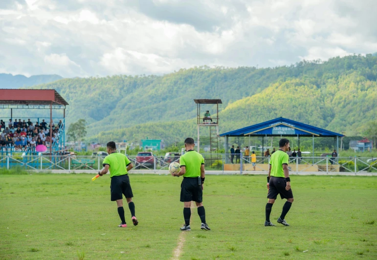 a couple of men standing on top of a soccer field