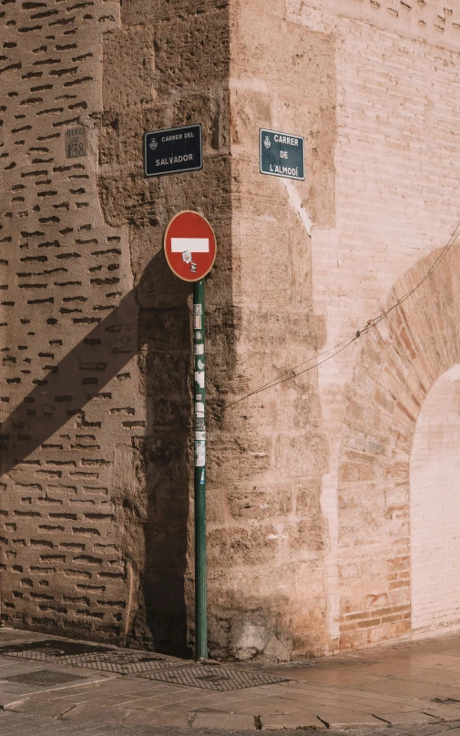 there is a red street sign next to a red and white sign