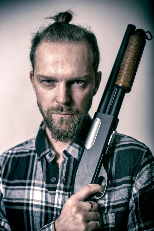 a man holding a gun in his hands
