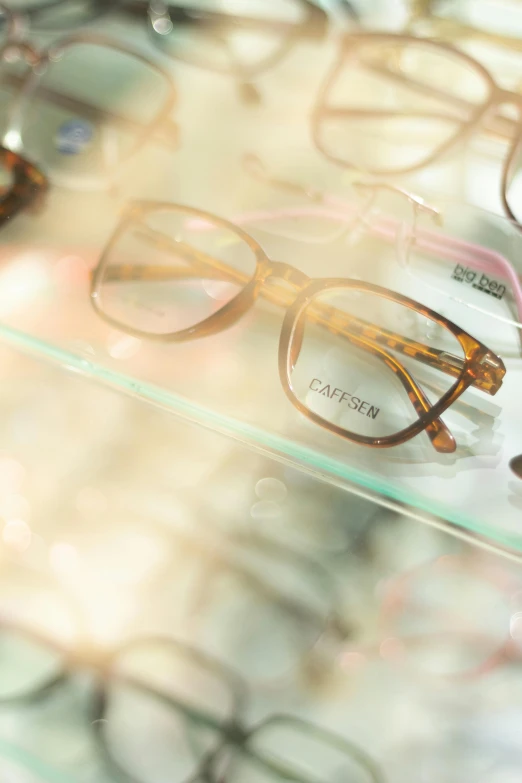 a couple of pairs of glasses sitting on top of a glass case